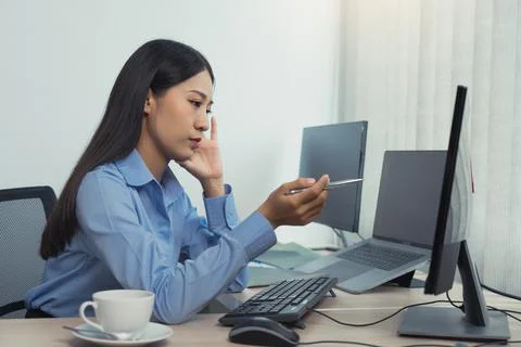 Stress asian woman while coding data programmer on desktop PC while working.. Stock Photos