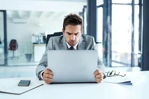 Stress, frown and angry man on laptop in office frustrated with glitch, mistake Stock Photos