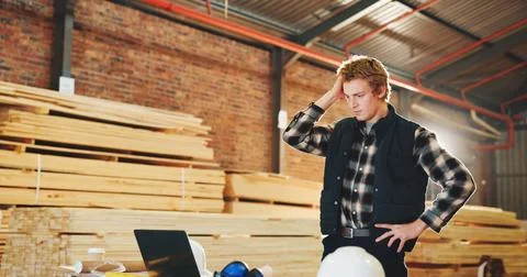 Stress, man and carpenter in workshop with laptop, bad news and feedback for Stock Photos