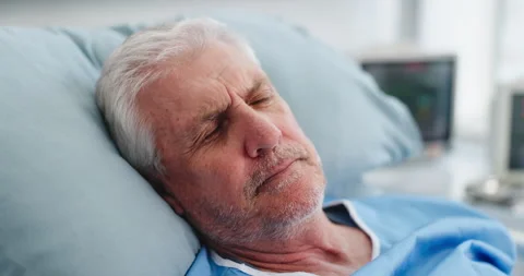 Stress, senior man and thinking in hospital bed for bad news, medical mistake Stock Footage 321860080