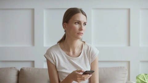 Stressed 30s lady thinking over relations breakup after reading sms. Stock Footage 120735261