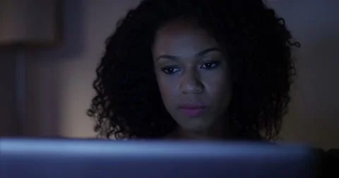 A stressed African American businesswoman working late at night from home. Stock Footage