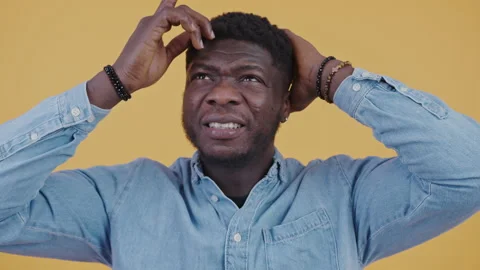 Stressed Afro-American man doing calculations in head tensed over losing money Stock Footage 234019071