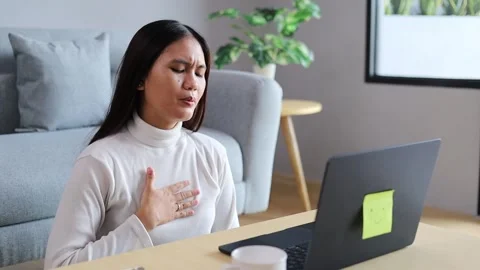 Stressed Asian freelancer has panic attack at home. Businesswoman works on Stock Footage 328625329