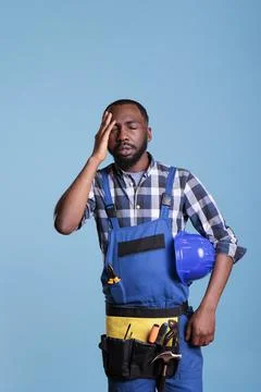 Stressed builder feeling fatigue and headache Stock Photos