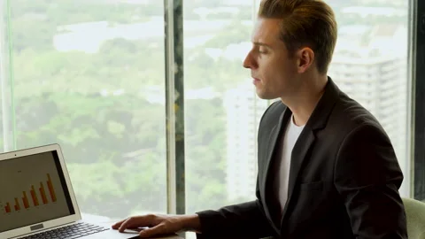 Stressed business man looking to information data in laptop computer near win Stock Footage 158466902