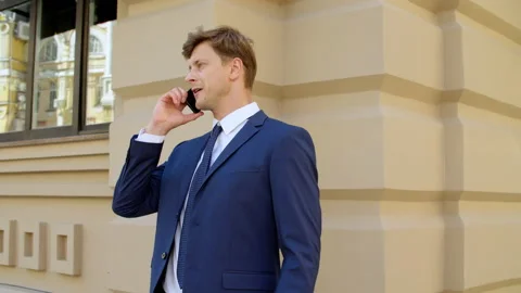 Stressed business man talking mobile phone outdoors. Angry businessman Stock Footage