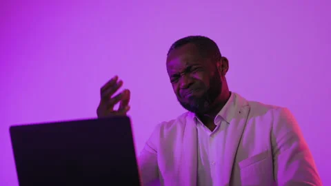 Stressed businessman holding head while working on laptop, frustrated man facing Video stock 326071880