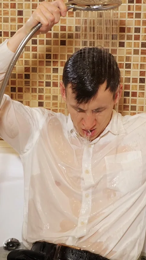 Stressed businessman taking a cold shower with clothes on after a hard days work Stock Footage 344823374