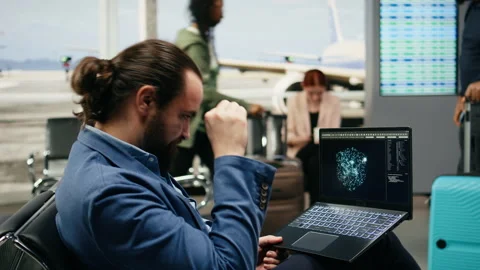 Stressed businessman using AI deep learning systems on laptop in airport lounge Stock Footage 339643005