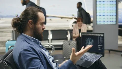Stressed businessman using AI deep learning systems on laptop in airport lounge Stock Photos