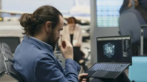 Stressed businessman using AI deep learning systems on laptop in airport lounge Stock Photos