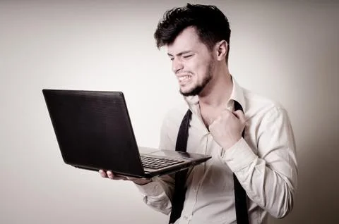 Stressed businessman using notebook Stock Photos
