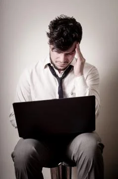 Stressed businessman using notebook Stock Photos