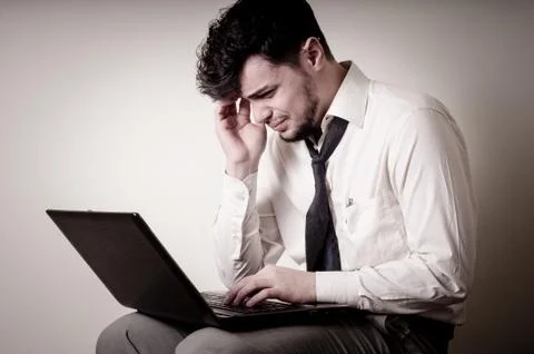 Stressed businessman using notebook Stock Photos