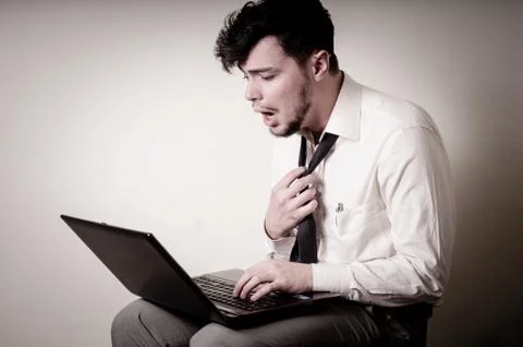 Stressed businessman using notebook Stock Photos