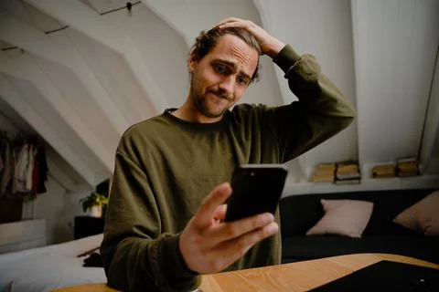 Stressed caucasian student checking empty bank balance on smartphone struggling Stock Photos