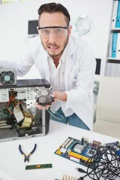 Stressed computer engineer showing broken fan Stock Photos