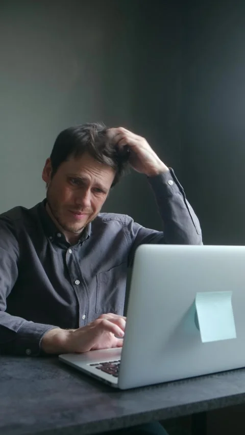 Stressed confused man scratching head while working on laptop Stock Footage 337892305