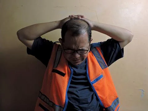 Stressed Construction Worker Holding Head in Frustration Stock Photos