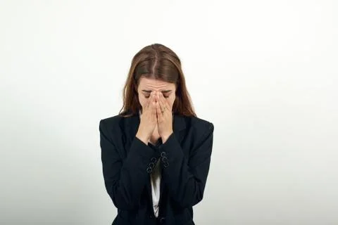Stressed covered face with hands, crying feels desperate. Fear,shame, violence. Stock Photos