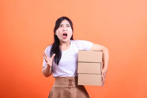 Stressed delivery person with boxes Stock Photos