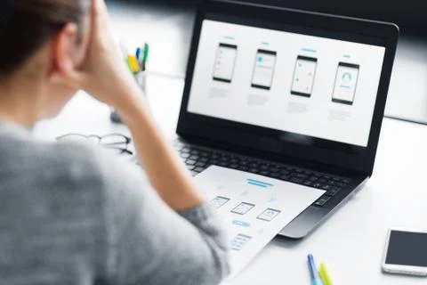 Stressed designer with user interface on laptop Foto stock