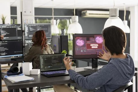 Stressed developer reacts with shock to critical system error on computer Stock Photos
