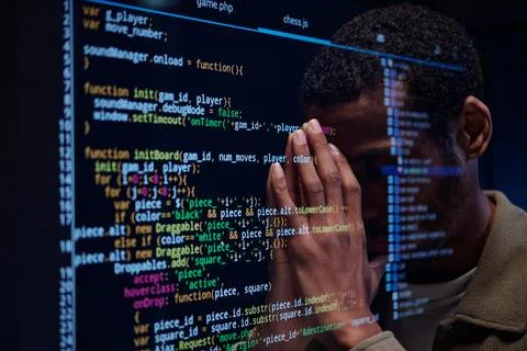 Stressed Developer Reviewing Complex Code on Screen Stock Photos