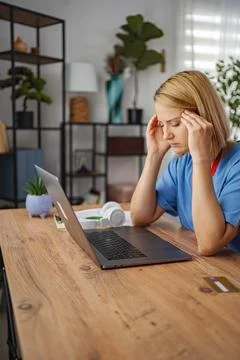 Stressed doctor having headache while working from home Stock Photos