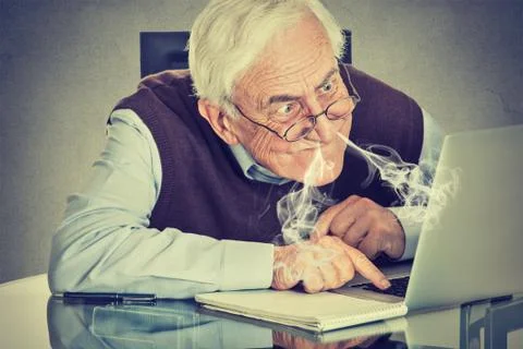 Stressed elderly man using computer Stock Photos