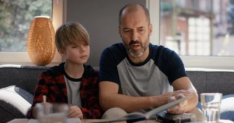 Stressed Father helps son doing homework Video stock 128828401