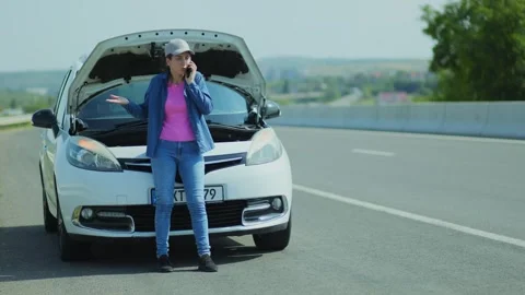 Stressed Female Driver Requests Roadside Assistance Using Her Mobile Phone Stock Footage 329403995