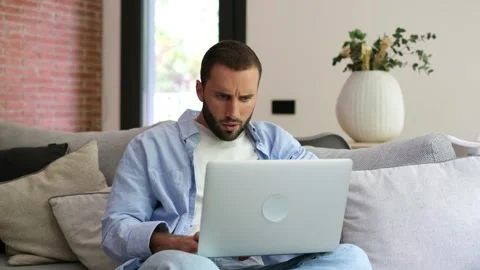 Stressed freelancer feeling tired while working from home on a laptop Stock Footage 335588542