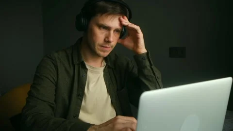 Stressed freelancer reading documents and working on laptop at home Video stock 313235148