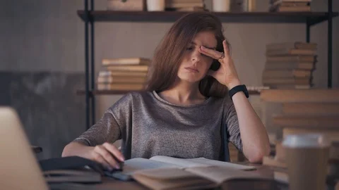 Stressed ginger young student working with books at home Stock Footage 115604365