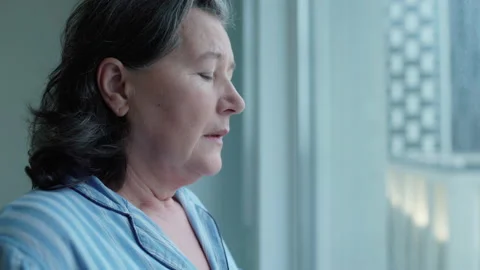 Stressed grandmother drinking tea, thinking about problem, painful memories Stock Footage 146392973