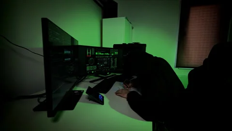 Stressed Hacker Writing Down Code Errors in Rush While Staring at Monitors Fast Stock Footage 306590606