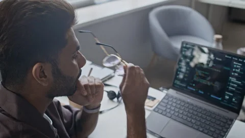Stressed Indian Programmer Rubbing Eyes and Coding on Laptop in Office Video stock 337493143