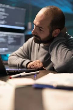Stressed male developer leaning on hand with pensive expression 스톡 사진