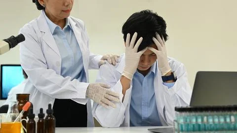 Stressed male scientist feeling tired, upset or having problems results of the Stock Photos