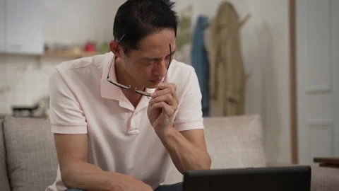 Stressed male working from home with tired eyes Stock Footage 251826853