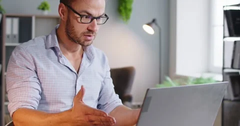 Stressed man arguing on laptop during online chat at home office, work problem Stock Footage 329288133