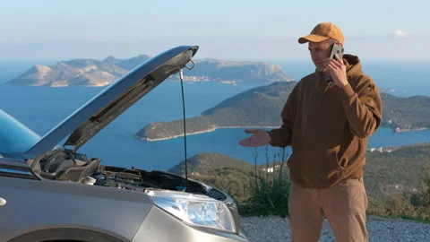 Stressed man calling roadside assistance for broken car. Stock Footage 333214873