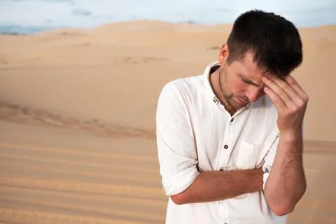 Stressed man in desert alone. Stock Photos