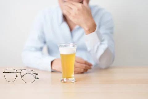 Stressed man drinking beer alone with problem. Exhausted drunk man looking .. Stock Photos
