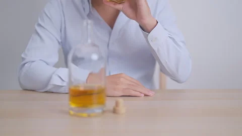Stressed man drinking whiskey alone with problem. Exhausted drunk man looki.. Stock Footage 345101753