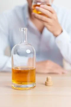 Stressed man drinking whiskey alone with problem. Exhausted drunk man looki.. Stock Photos