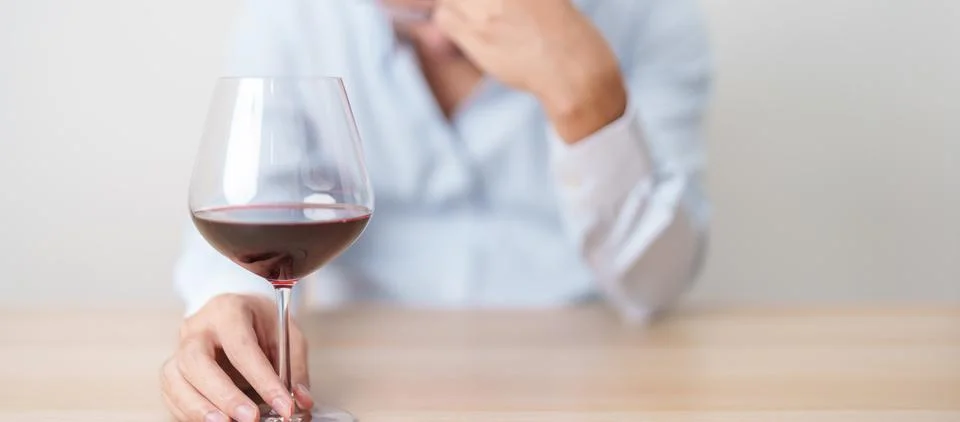 Stressed man drinking Wine alone with problem. Exhausted drunk man looking .. Stock Photos