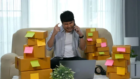 Stressed man entrepreneur talking problem on a smartphone and working Video stock 144614360